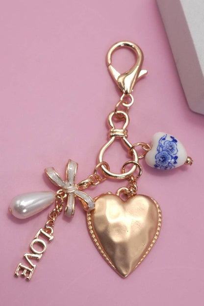 PORCELAIN BOW HEART LOVE BAG CHARM | Gold